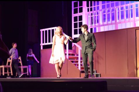 Elle Woods and Warner Huntington III are seen onstage together.