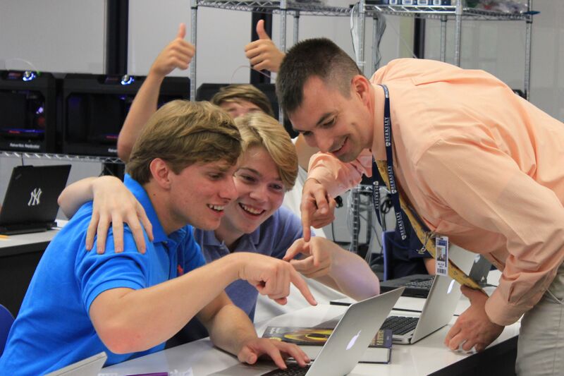 Mr. Smith makes AP Computer Science come alive, and seniors Lance Esposito (left), Boone Fisher (right), and Robert Baldy (background) are loving their new teacher. Additionally, Mr. Smith worked in the Navy for 11 years, spending much of his time working with the NSA.