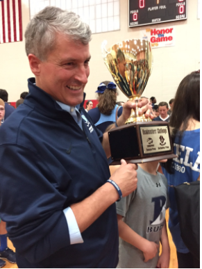 Headmaster Seivold proudly holds the Headmaster’s Cup.