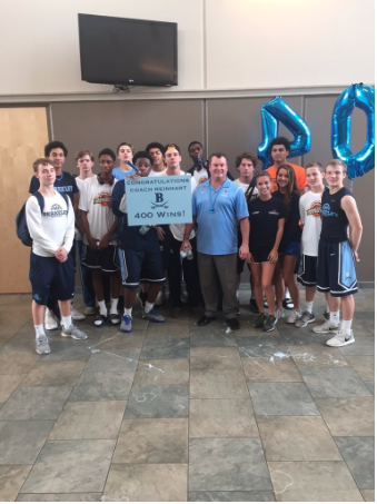 The basketball team poses for a picture after Reinhart's 400th win. 