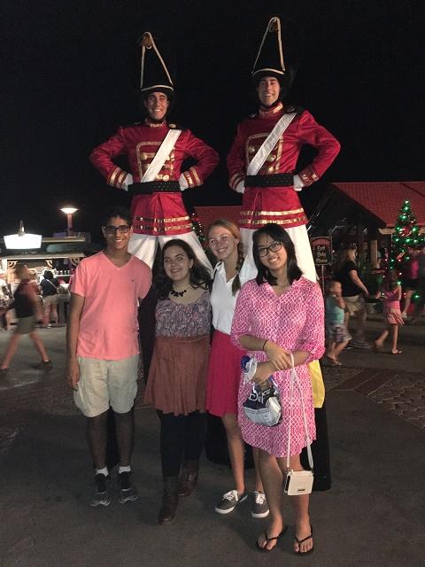 HELLO UP THERE: During the holiday season, you can meet cast members walking around the park in special outfits. But they might be a little... tall. From left: Arjun Gandhi '18, Dina Al-Hassani '16, Emma Edmund '18 and Samantha Tun '17.