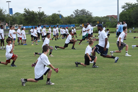 LEFT LEG LUNGE: Agholor taught the kids the importance of warming up and getting loose in order to avoid injury before the actual skill instruction began.