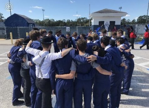 BAND TOGETHER: The marching band huddles up after 
their second competition of the year.