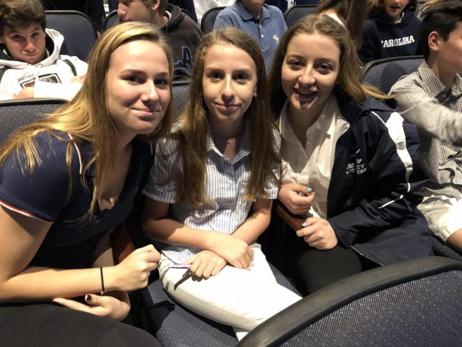 UPPER DIVISION CONVO: Eighth graders also experienced Upper Division convo, taking the seats of the freshmen as they completed their service trip.  Emily Esposito ’22, Mila Oliva ’22 and Cayley Rogers ’22 (from left) wait patiently for convo to begin.