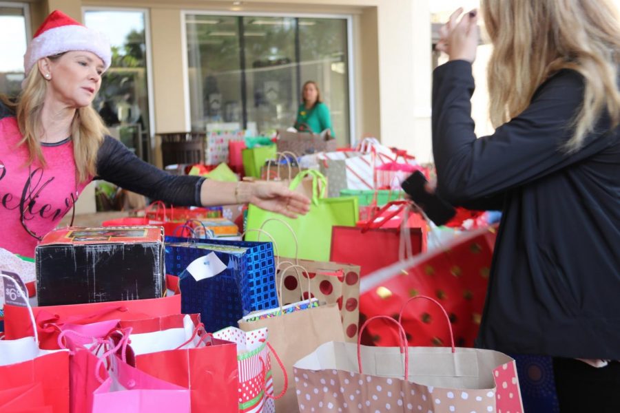 SANTA’S HELPERS: Even the Berkeley Moms are helping the community by organizing the presents.  Parent Kelly Varsames (left) organizes the annual Wrap-In gift delivery to the children of Redlands Christian Migrant Association.