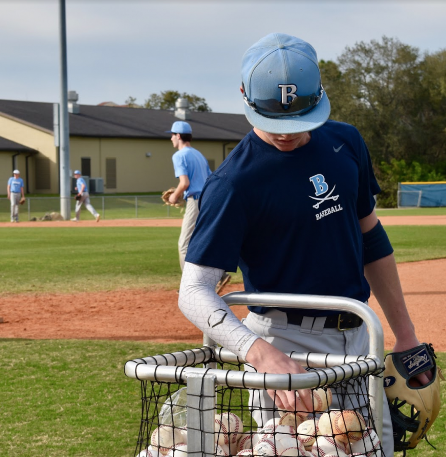 JUST RIGHT: Cade Kurland ’23 hunts for the perfect ball to practice with.