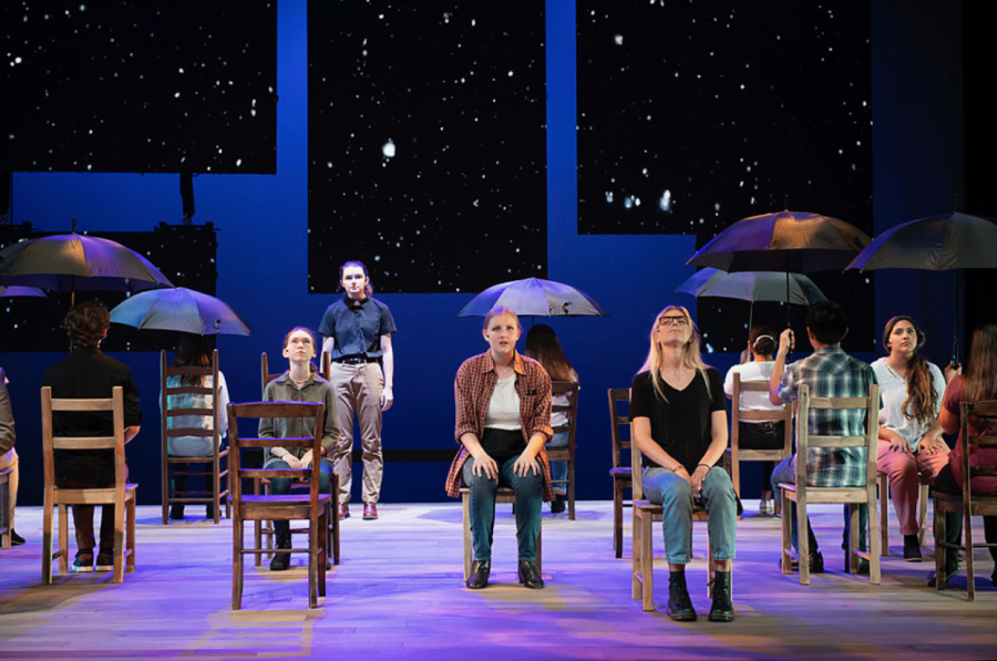 MATTHEW’S FUNERAL: Charlotte Graham ‘21 plays a priest who leads Matthew’s service, while snow falls from the sky. Photo from the Theater Department. 
