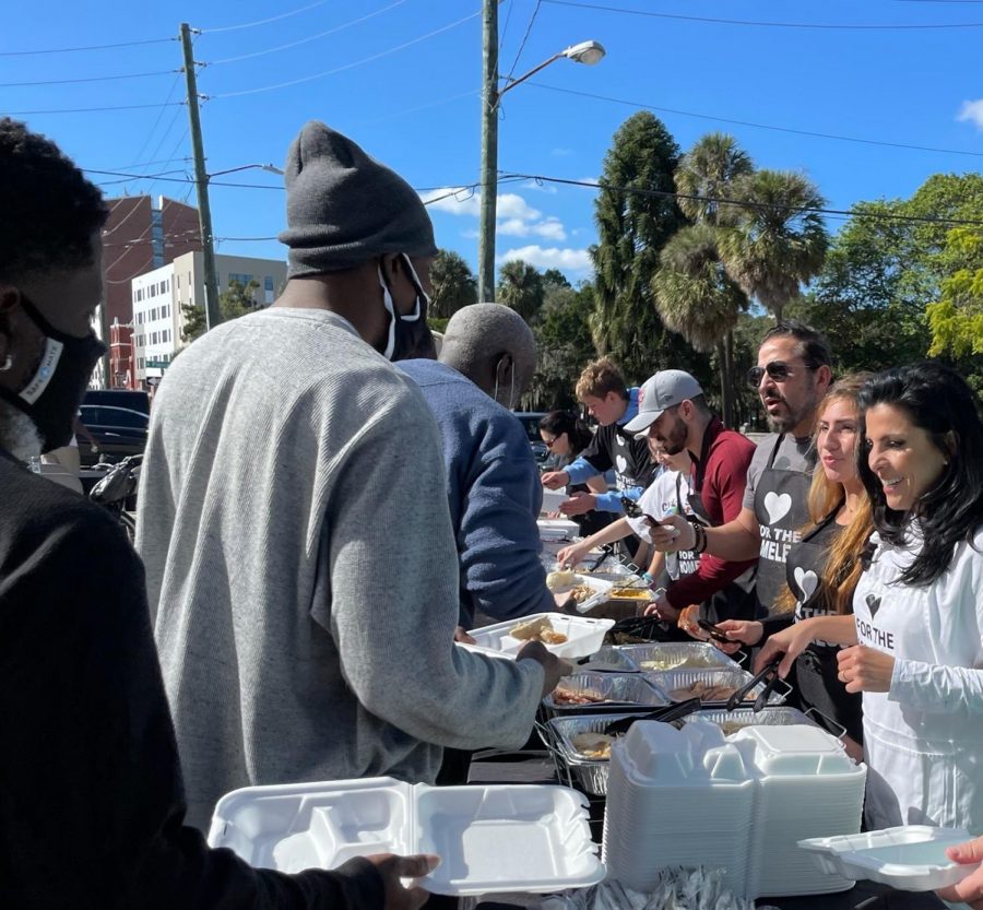 EAGER TO EAT: The Kelley family, joined by several Berkeley students, serve Golden Corral and homemade meals to the homeless.