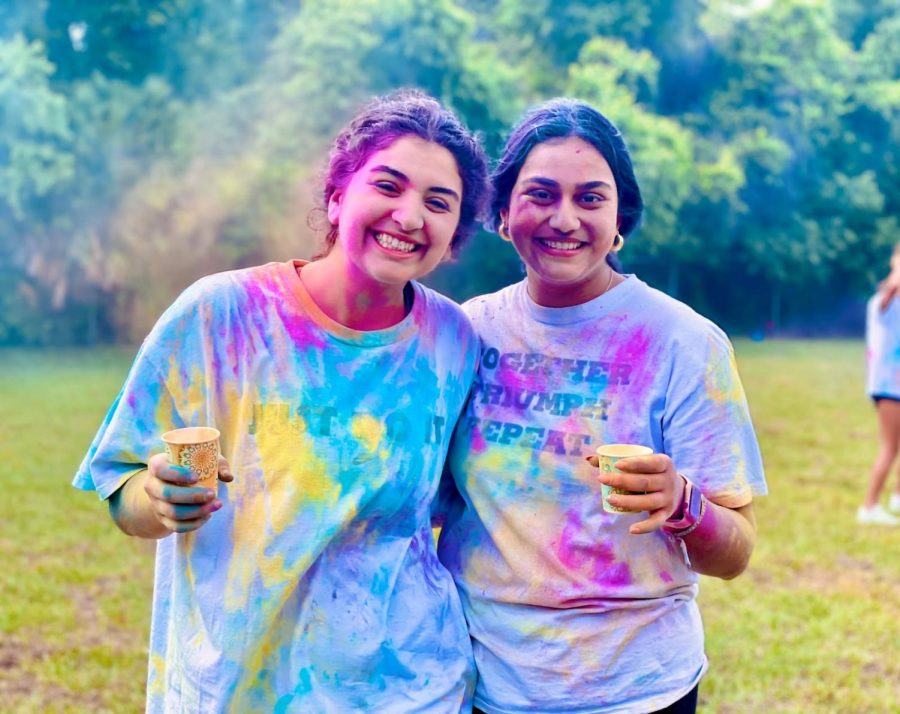 COVERED IN COLOR: Sophia Vasiloudes ’22 and Isha Patel ’24 pictured, shirts covered in multi-colored pigments.