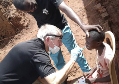 The Rev. Tom Wall, a United Methodist campus minister at the University of South Carolina, brushes a boy’s teeth during a free health camp in eastern Uganda. The United Methodist Church in Uganda and the African Methodist Episcopal Church jointly sponsored the weeklong event. Wall served as the team leader of the group from the United States. Photography credit: Vivian Agaba, UM News.