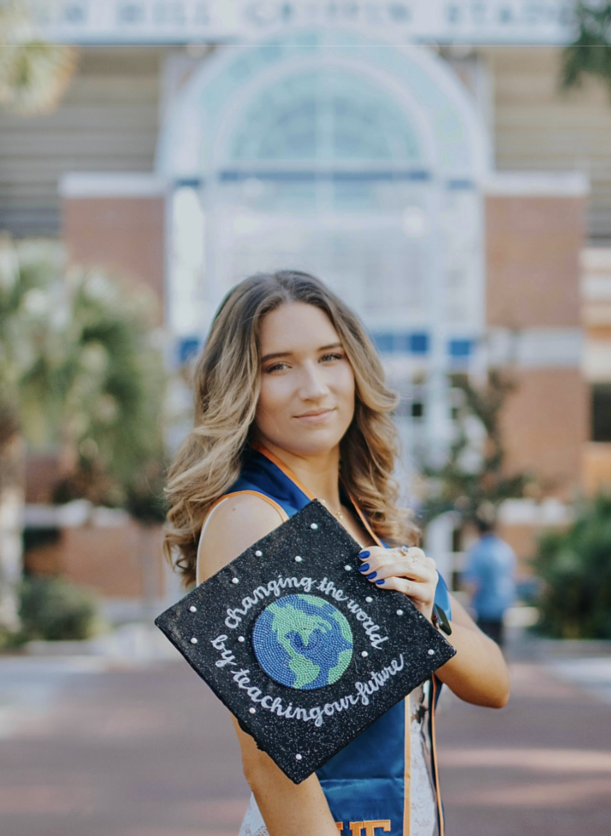 Gator at Heart: Vega shows off her bedazzled teacher-themed 
graduation cap from the University of Florida.

