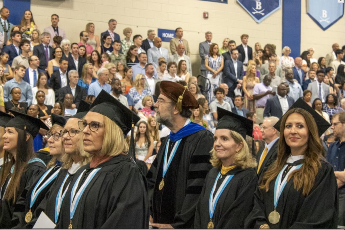 Gowns and Cap: Berkeley faculty wait for their students to move on; Dr. Kuswa sports a spiffy hat. 