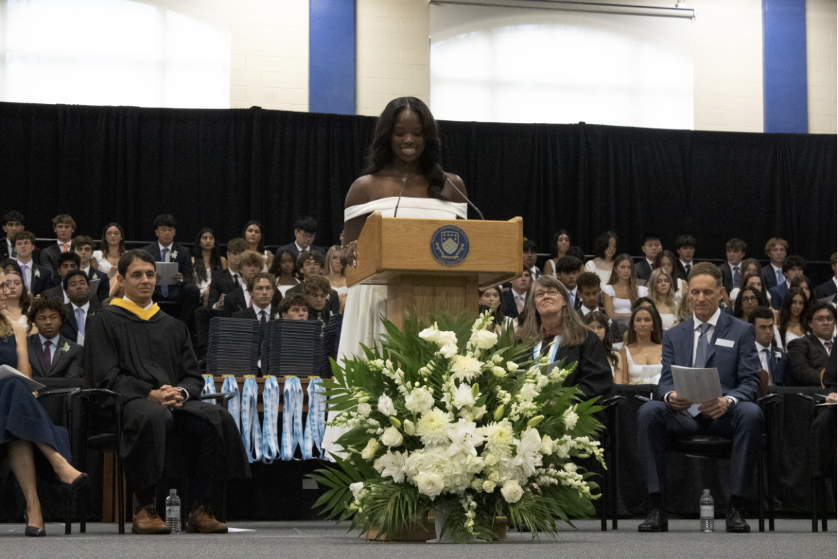 CELEBRATING HOW FAR WE’VE COME: Lexi McFarland ’26 smiles as she encourages the graduating class to believe in themselves as they look towards the future